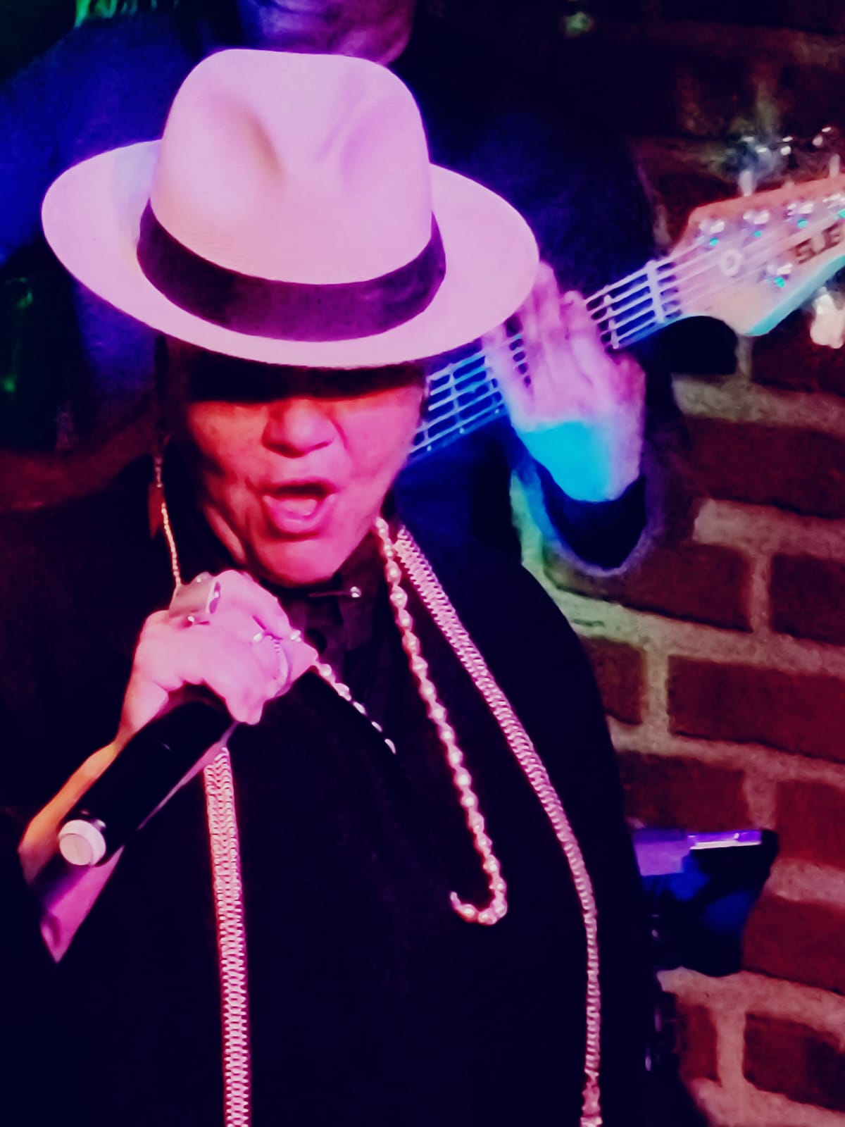 Lady Zen performing under purple light
