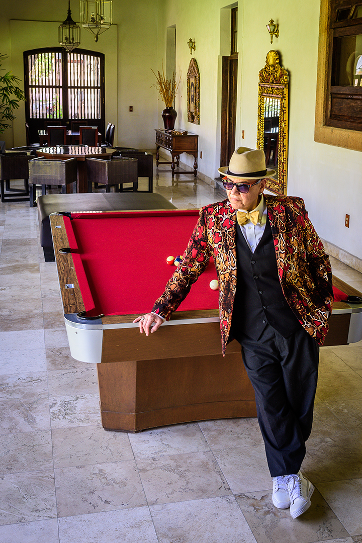 Lady Zen by pool table in patterned jacket